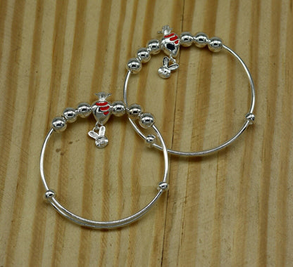 Sterling silver adjustable charm bangle bracelet by Tribal Ornaments, unisex kids and baby jewelry with intricate design.