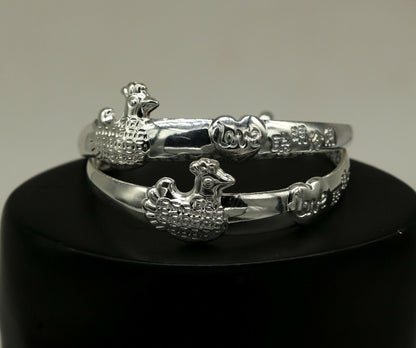 Sterling silver adjustable charm bangle bracelet by Tribal Ornaments, unisex kids and baby jewelry, featuring engraved design.