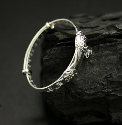 Unisex 925 sterling silver adjustable charm bangle bracelet with intricate tribal ornament design for kids and babies.