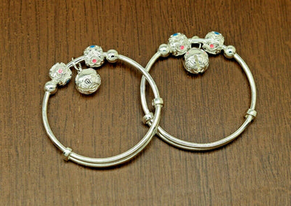 Sterling silver adjustable charm bangle bracelet by TRIBAL ORNAMENTS, unisex kids and baby jewelry with detailed design.