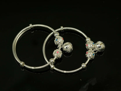 Sterling silver adjustable charm bangle bracelet by TRIBAL ORNAMENTS, unisex kids and baby bracelet with decorative charms.