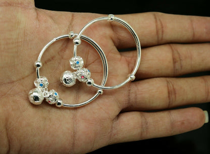 Sterling silver adjustable charm bangle bracelet by Tribal Ornaments, unisex kids and baby jewelry with intricate design.