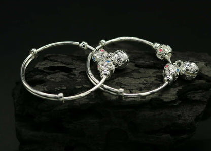 Unisex 925 sterling silver adjustable charm bangle bracelet with intricate tribal design for kids and babies.