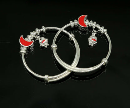 Sterling silver adjustable charm bangle bracelet by TRIBAL ORNAMENTS, unisex kids and baby bracelet with decorative charms.