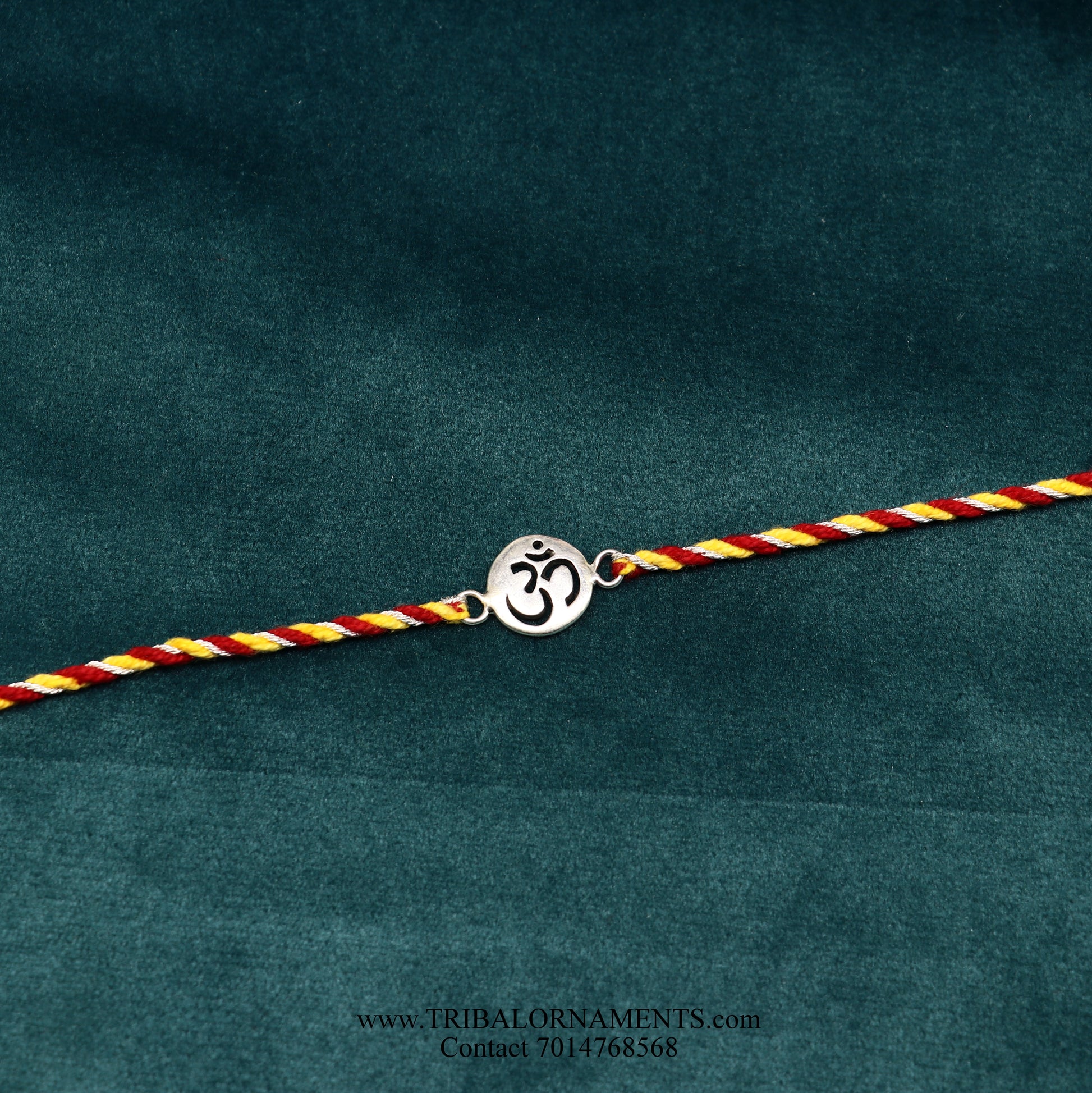 Sterling silver handmade AUM design thread bracelet by TRIBAL ORNAMENTS with intricate tribal-style detailing.