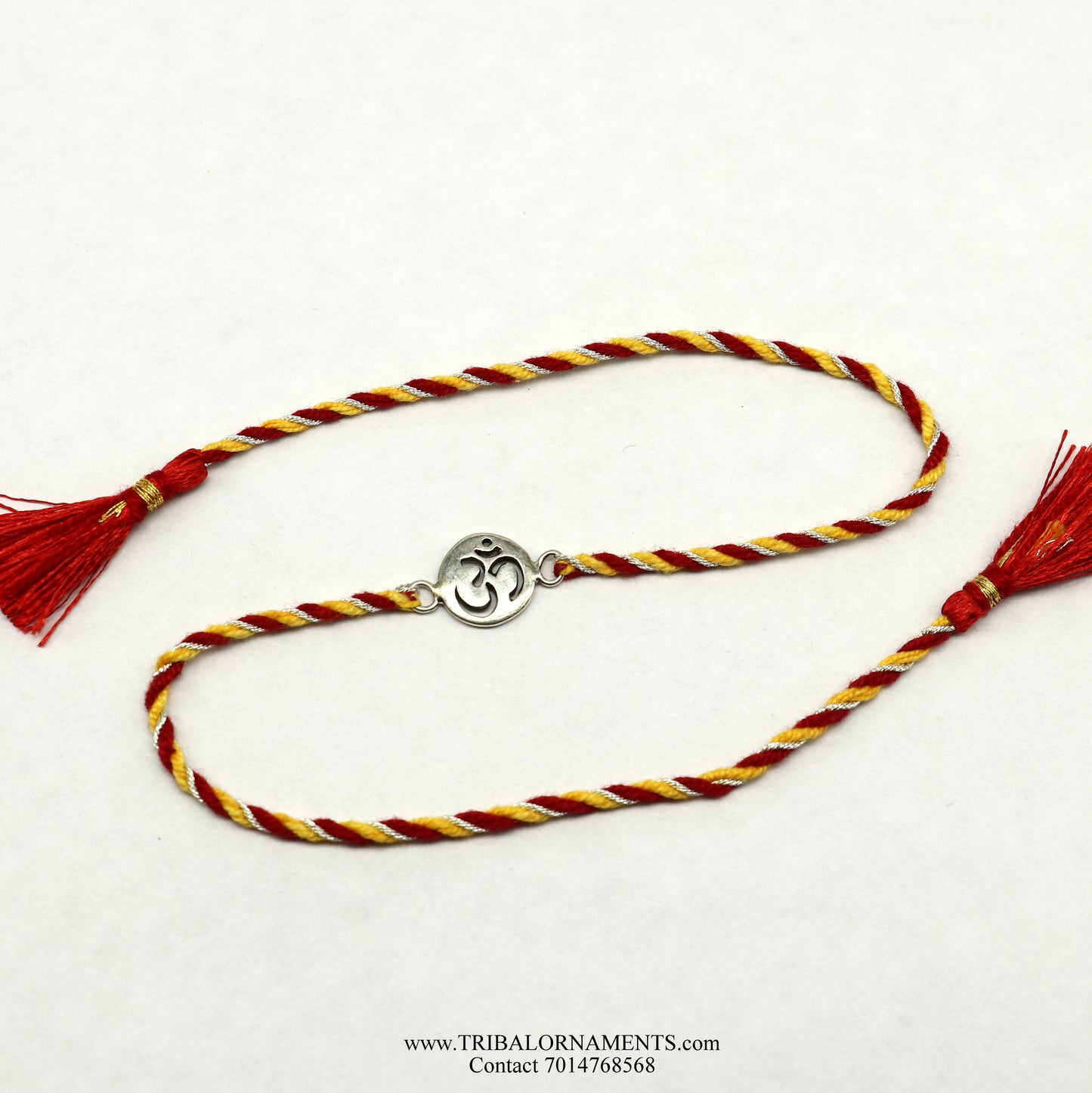 Sterling silver handmade AUM design bracelet by TRIBAL ORNAMENTS, featuring intricate thread craftsmanship and stylish details.