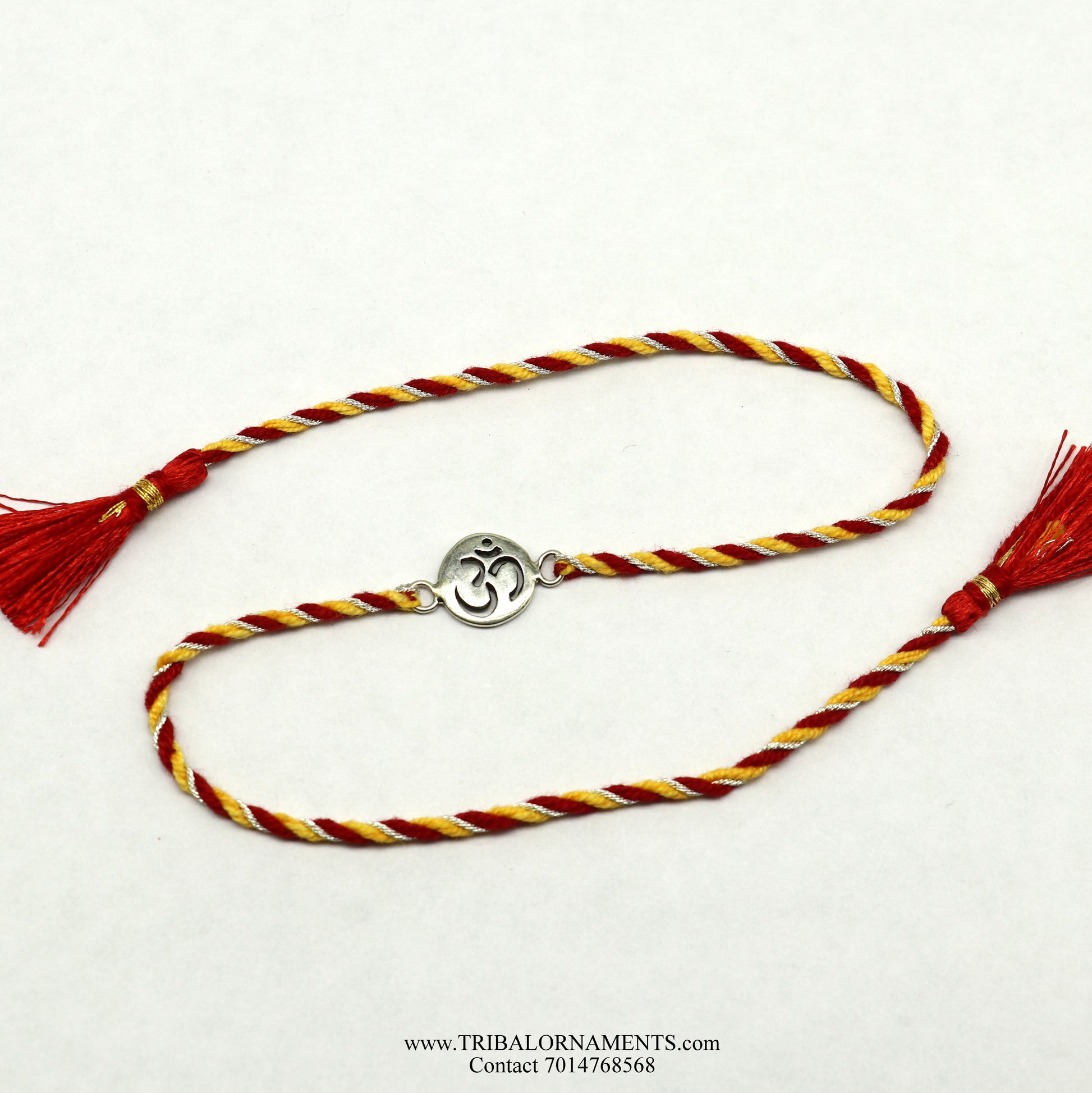 Sterling silver handmade AUM design bracelet by TRIBAL ORNAMENTS, featuring intricate thread craftsmanship and stylish details.