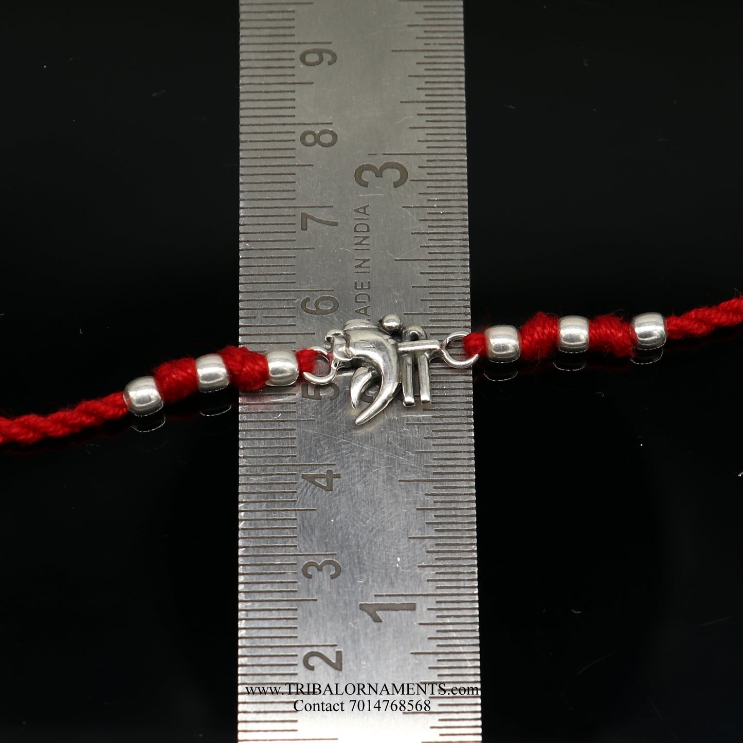 Sterling silver handmade Shree Ganesha bracelet by TRIBAL ORNAMENTS featuring intricate design and thread attachment.