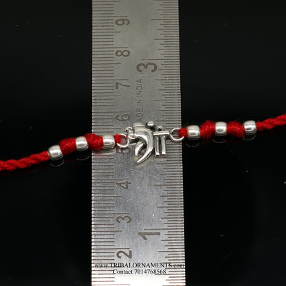Sterling silver handmade Shree Ganesha bracelet by TRIBAL ORNAMENTS featuring intricate design and thread attachment.
