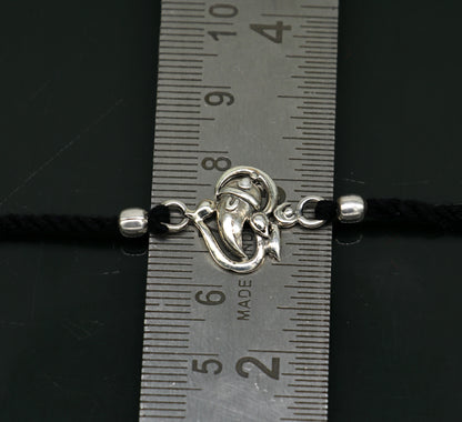 925 sterling silver Om and Ganesha design bracelet by TRIBAL ORNAMENTS, featuring intricate thread Rakhi style craftsmanship.