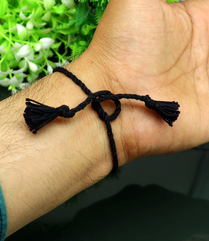 Sterling silver Om with Ganesha design bracelet by TRIBAL ORNAMENTS, featuring intricate thread rakhi style craftsmanship.