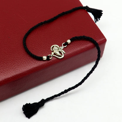 Sterling silver Om with Ganesha design bracelet by TRIBAL ORNAMENTS, featuring intricate thread rakhi style craftsmanship.