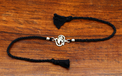 Sterling silver Om Ganesha design bracelet by TRIBAL ORNAMENTS, featuring intricate thread bracelet with spiritual motifs.