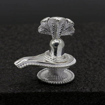Small solid 1.2-inch sterling silver Lord Shiva lingam stand, handmade tribal ornament for puja and prosperity rituals.