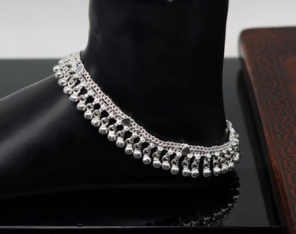Sterling silver 10.5-inch double chain anklet with waved jingle bells and charm, perfect for belly dance jewelry or casual wear.