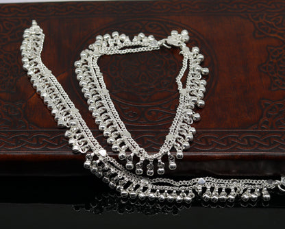 Sterling silver double chain anklet with waved design, jingle bell charms, perfect for belly dance accessories and foot jewelry.