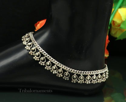 Vintage 10.5-inch sterling silver anklet with tribal charms, handmade antique ethnic jewelry worn around the ankle.