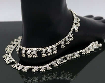 Handmade 10-inch sterling silver ankle bracelet with tiny drop charms, crafted by TRIBAL ORNAMENTS for stylish ankle jewelry.