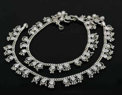 Handmade sterling silver ankle bracelet with tiny drop charms, crafted by TRIBAL ORNAMENTS, perfect for customized jewelry gifting.
