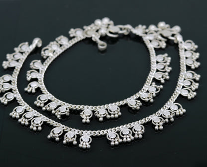 Handmade 10-inch sterling silver ankle bracelet with tiny drop charms, crafted by TRIBAL ORNAMENTS, ideal for customized gifting.