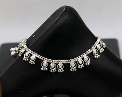Handmade 10-inch sterling silver ankle bracelet with tiny drop charms, featuring detailed craftsmanship from TRIBAL ORNAMENTS.