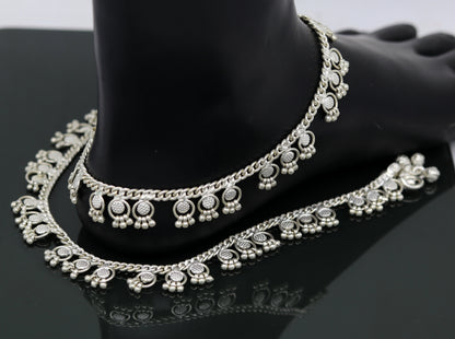Sterling silver ankle bracelet by Tribal Ornaments with tiny drop charms, handmade jewelry perfect for customized gifting.