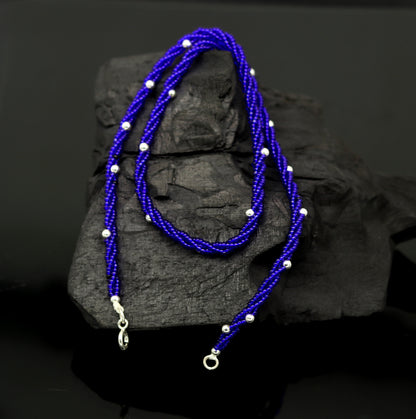 Sterling silver galaxy necklace with triple strands, blue semi-precious stone beads, and silver accents, designed by TRIBAL ORNAMENTS.
