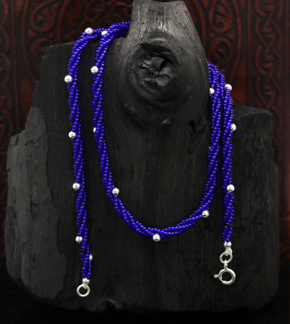 Sterling silver galaxy necklace with triple strands, blue semi-precious stone beads, and silver accents, designed by TRIBAL ORNAMENTS.