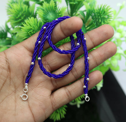 18.5-inch sterling silver galaxy necklace set with triple strands of blue semi-precious stones and randomly placed silver beads.