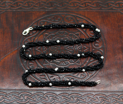 18-inch TRIBAL ORNAMENTS silver galaxy necklace set with triple strands of semi-precious black cut stone beads and silver accents.