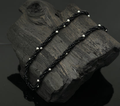 18-inch silver galaxy necklace by Tribal Ornaments featuring triple strands of semi-precious black cut stone beads with silver accents.