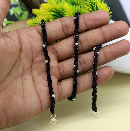 18-inch silver galaxy necklace by TRIBAL ORNAMENTS with triple strands, black cut stones, and silver beads.