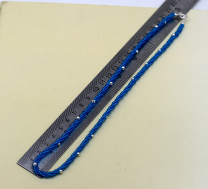 Sterling silver galaxy necklace with triple strands, blue semi-precious stone beads, and silver accents, by TRIBAL ORNAMENTS.