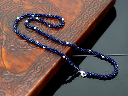 18-inch Tribal Ornaments beaded necklace with triple strands, semiprecious cut stones, and silver beads in a galaxy-inspired design.