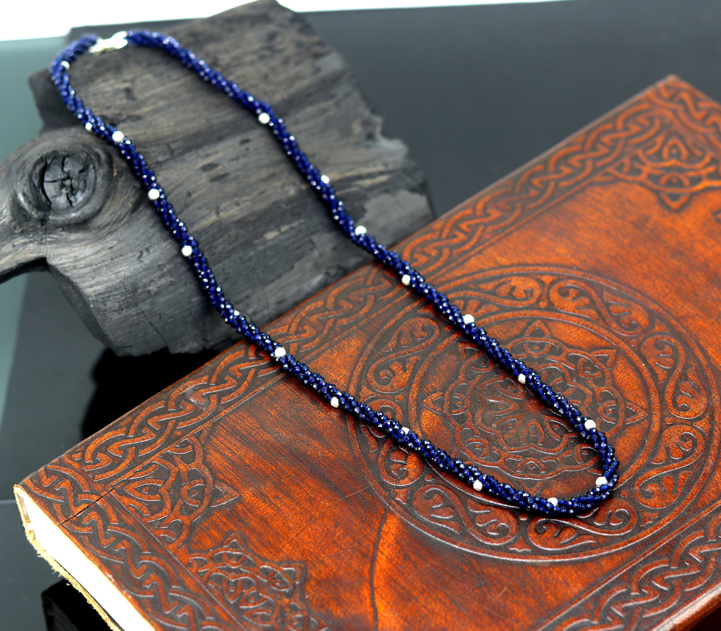 18-inch TRIBAL ORNAMENTS beaded necklace with triple strands of semiprecious cut stones and silver beads, galaxy-inspired design.