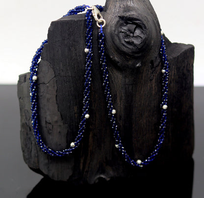 18-inch tribal beaded necklace with triple strands, semiprecious cut stones, and silver beads, featuring a galaxy-inspired design.