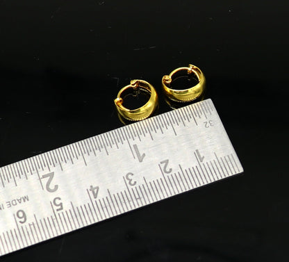 18kt yellow gold handmade customized huggie hoop earrings by TRIBAL ORNAMENTS, perfect for brides, clip-on design, fine jewelry.