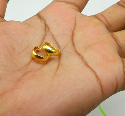 18kt yellow gold handmade huggie hoop earrings by TRIBAL ORNAMENTS, custom-designed clip-on jewelry for brides.