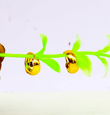 18kt yellow gold handmade huggie hoop earrings by Tribal Ornaments, custom-made clip-on bridal jewelry with intricate design.
