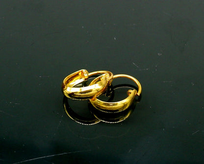 18kt yellow gold handmade custom huggie hoop earrings by TRIBAL ORNAMENTS, perfect for brides, clip-on style jewelry.