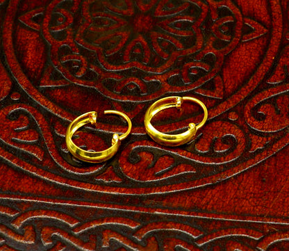 18kt yellow gold handmade customized huggie hoops earrings by TRIBAL ORNAMENTS, clip-on style for brides or elegant wear.