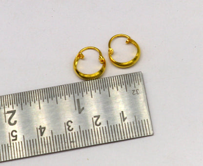 18kt yellow gold handmade customized huggie hoop earrings by TRIBAL ORNAMENTS, clip-on style, elegant bridal jewelry.