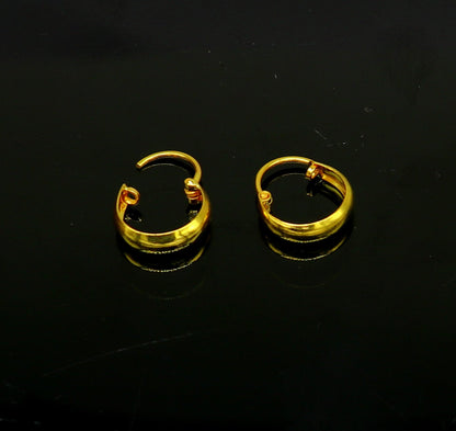 18kt yellow gold handmade customized huggie hoop earrings by TRIBAL ORNAMENTS, clip-on style for brides and elegant jewelry.