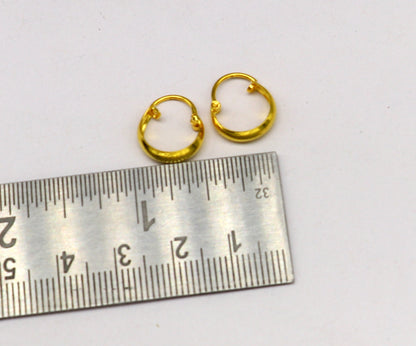 18kt yellow gold handmade customized huggie hoop earrings by TRIBAL ORNAMENTS, clip-on design for brides or elegant wear.