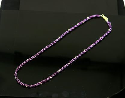 Tribal Ornaments 19-inch customized beaded necklace with triple strands of semi-precious purple beads and silver accents.