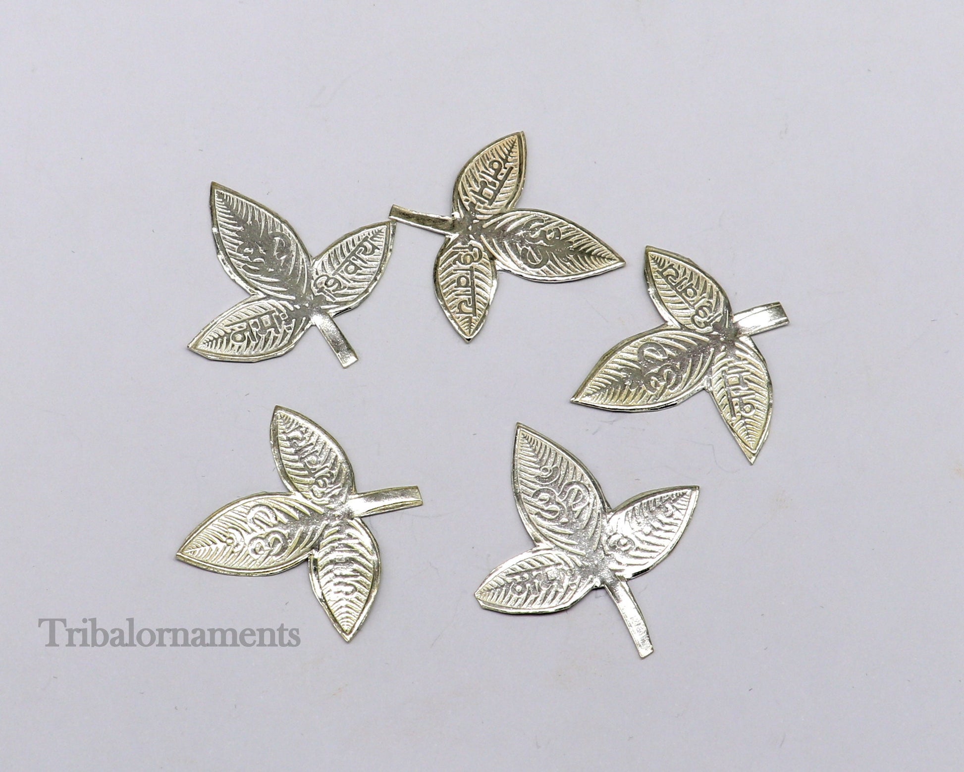 Solid silver 2.5 cm bel patra leaf for Lord Shiva worship, handmade by Tribal Ornaments, used in puja rituals.