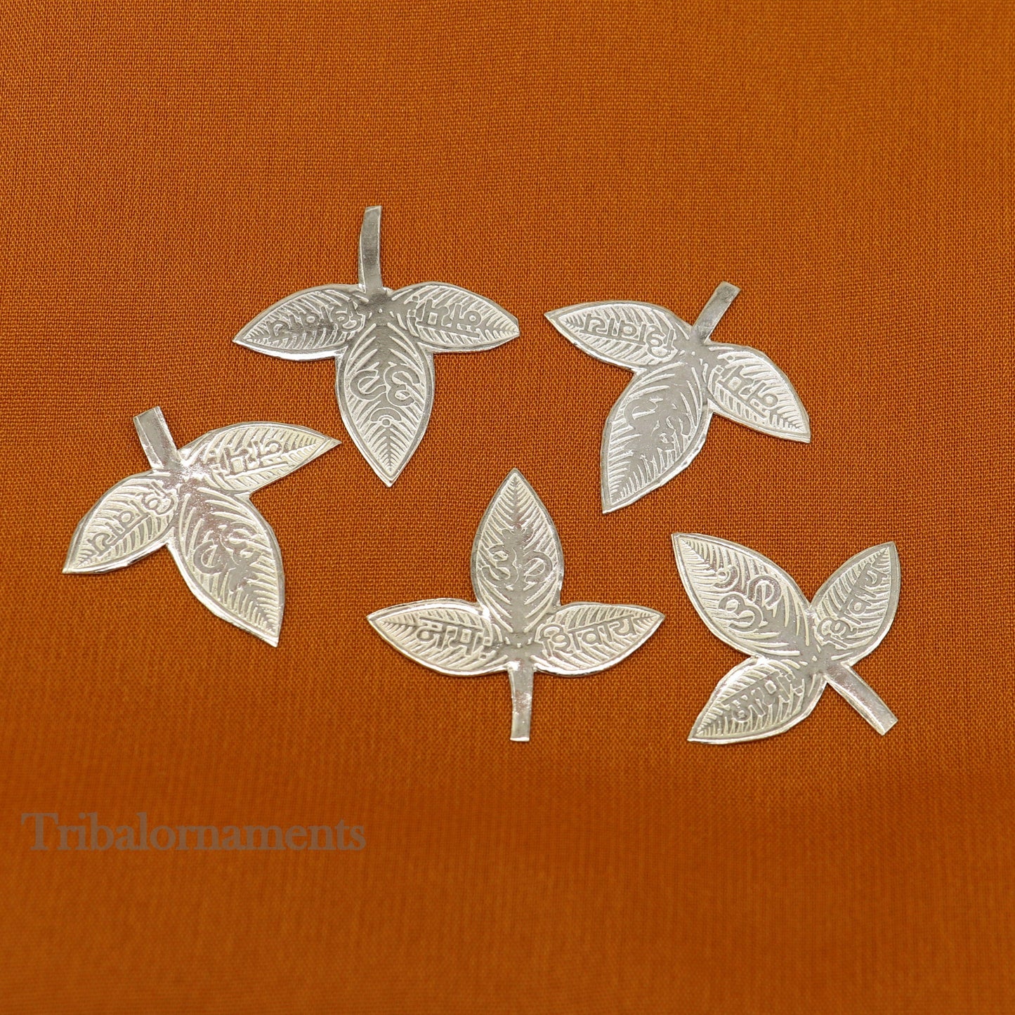 Solid silver 2.5 cm bel patra leaf for Lord Shiva puja, handmade tribal ornament for worship and spiritual rituals.