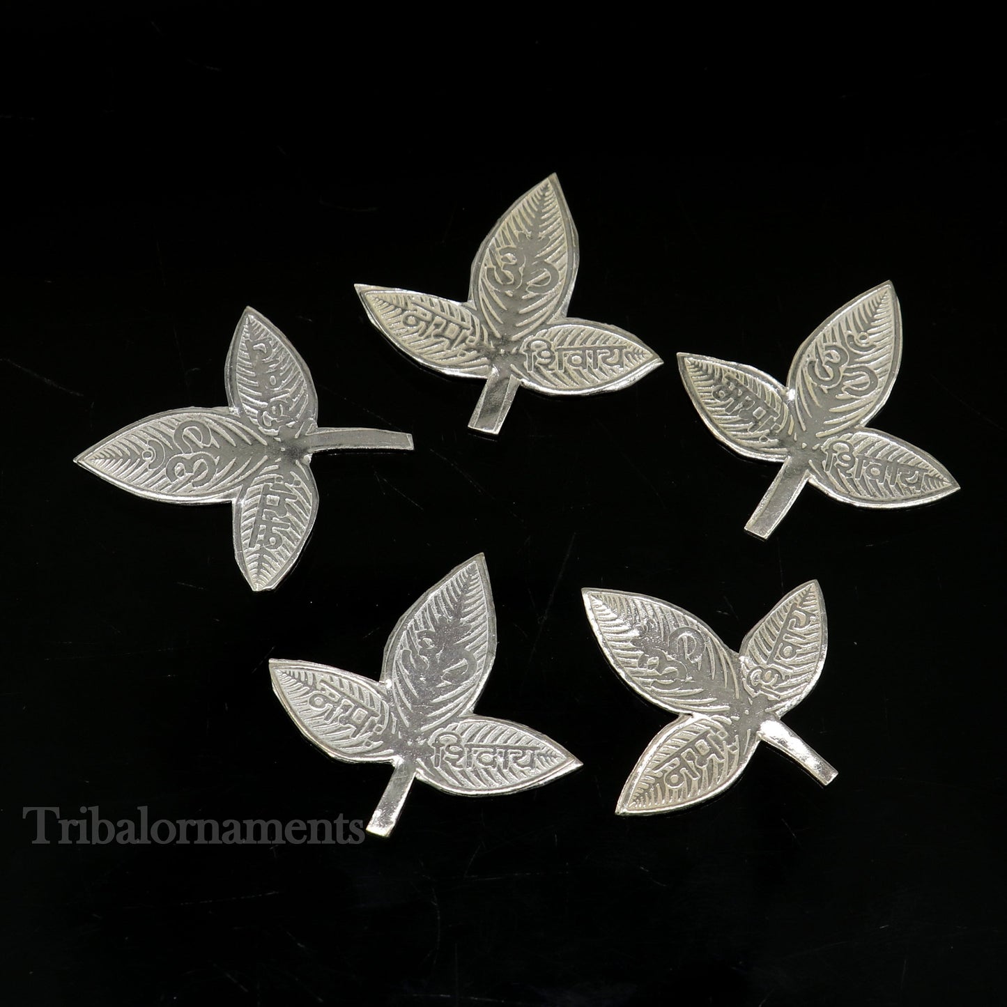 Solid silver 2.5 cm bel patra leaf for Lord Shiva worship, handmade by TRIBAL ORNAMENTS, used in puja rituals.