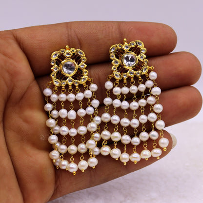 22K yellow gold handmade Kundan Jadau stud earrings with dangling pearls, tribal-inspired bridal jewelry design.