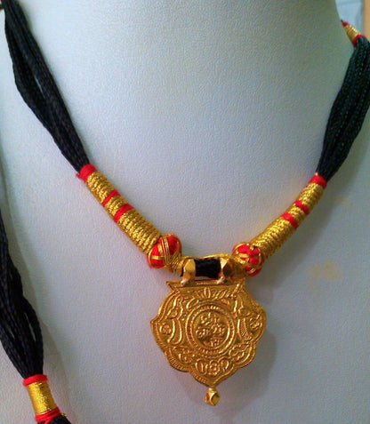22KT yellow gold handmade Shree Nathji tribal pendant from Rajasthan, showcasing intricate antique ethnic jewelry design.